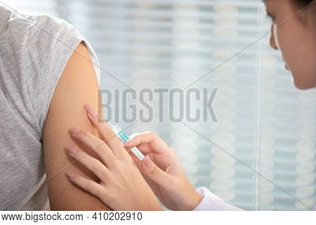 Close Up Doctor Holding Syringe And Make Injection To Patient  Covid-19 Or Coronavirus Vaccine And D
