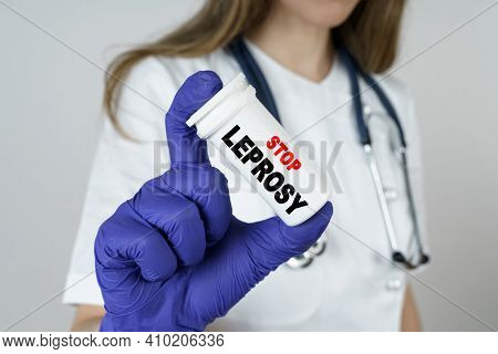 Medicine And Health Concept. The Doctor Holds A Medicine In His Hands, Which Says - Stop Leprosy