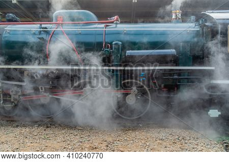 Antique Green Stream Locomotive's Starting Up Covering Of White Smoke To Be Prepared For Passengers