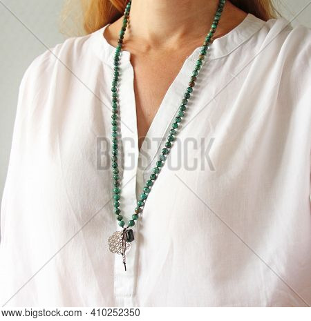 Rosary Mala 108 Beads From Natural Stones Chrysocolla Are Worn On A Girl In A White Shirt. Author's