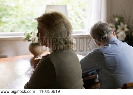 Rear View Of Mature Annoyed Quiet Husband And Wife