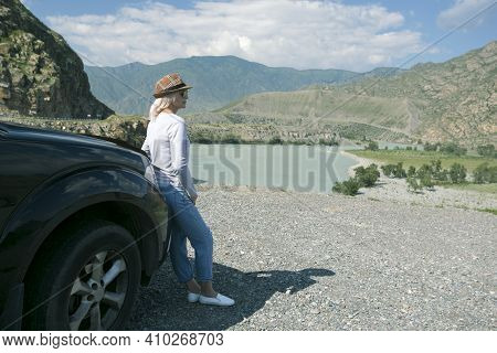 Woman Got Out Of The Car And Looks At The Mountains. Summer Travel ...