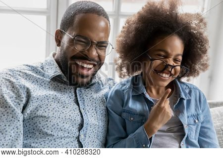 Overjoyed Black Dad And Kid Having Fun Together At Home