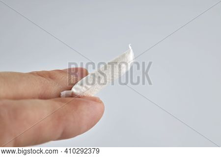 Snus Nicotine Product At Hand Palm. Copy Space. Stack Of White Small Bags In The Hand.
