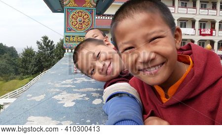 Bhaktapur, Kathmandu, Nepal - 18 October 2018 Laughing Ethnic Boys Of Monastery Smiling At Camera. A