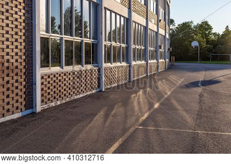 School Building And Schoolyard In The Evening