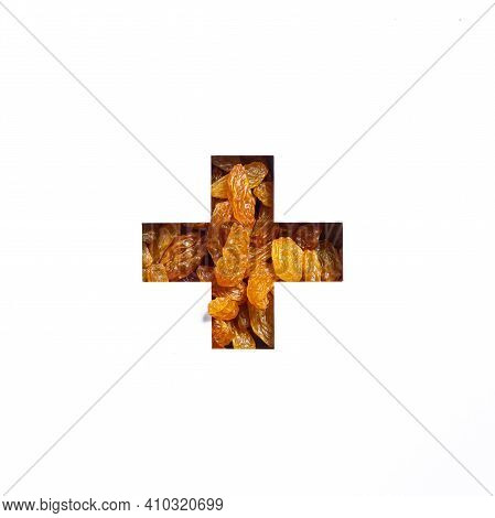 Plus Summation Sign Or Cross Of Raisins And Cut Paper Isolated On White. Typeface Made Of Dried Grap