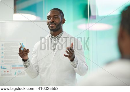 Waist Up Portrait Of African-american Man Standing By Whiteboard While Giving Presentation During Me