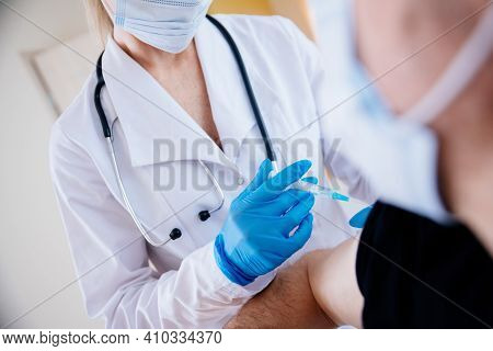 Close-up Of A Doctors Hand In A Protective Glove Making An Injection With The Vaccine.
