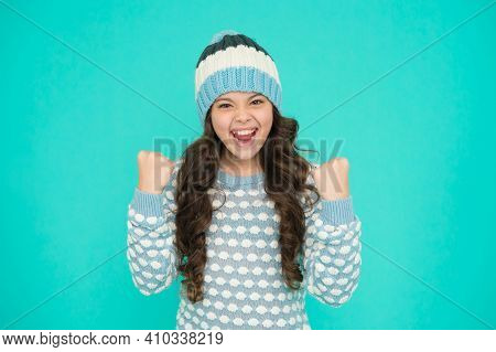 Happy Kid In Warm Sweater Selebrate Success. Keep Head In Warmth. Cozy And Comfortable. Best Winter 
