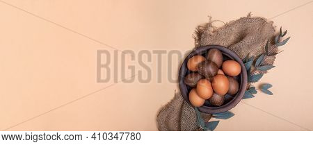 Clay Plate Full Of Painted Eastr Eggs On Sustainable Burlap Cloth