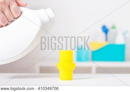 White Chlorine Bottle With Yellow Cover Mock-up. Toxic Detergent. Cleaning Supplies In Background. U