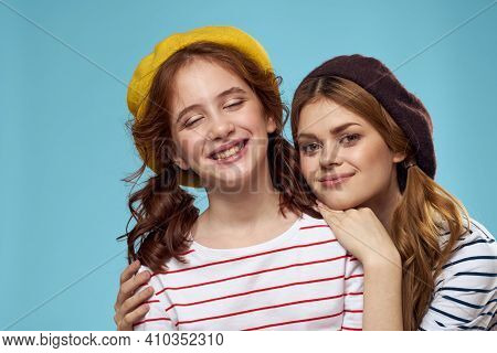 Fashion Sisters In Hats Fun Lifestyle Blue Background Studio