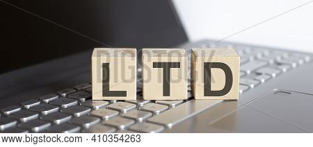 Ltd Abbreviation Stands For Anti Money Laundering Written On A Wooden Cube On The Aptop
