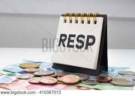 Resp Letters On Notebook With Coins And Bills On A Clear Background