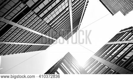 Bottom View Of Modern Skyscrapers In Business District Against Sky. Looking Up At Business Buildings