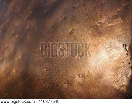 Metal Bronze Textured Plate. Bronze Or Copper Polished Surface With Dents, Scratches And Indentation