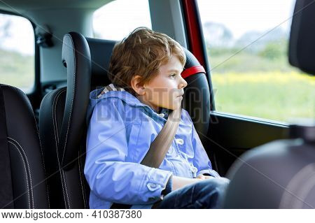Tired Preschool Kid Boy Sitting In Car During Traffic Jam. Sad Little School Child In Safety Car Sea