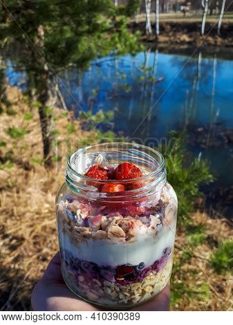 Healthy Breakfast Overnight Oats With Strawberries, Blueberries And Yoghurt In A Glass Jar With Beau