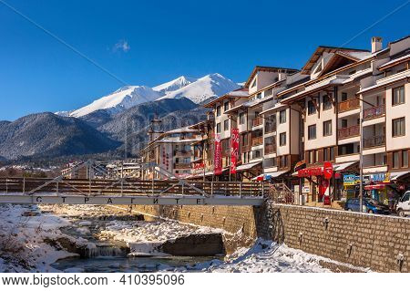 Bansko, Bulgaria - January 28, 2021: Glazne River In Bulgarian Town, Hotel Houses And Snow Pirin Mou