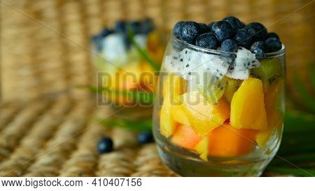 Colorful Tropical Mix Salad In Jar. Fresh Various Kind Of Raw Organic Berry And Fruit In Glass Bowl.