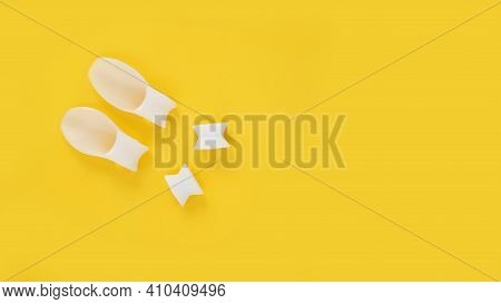 White Silicone Finger Divider On A Yellow Background. Prevention And Treatment Of Hallux Valgus