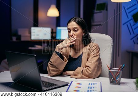 Exhausted Businesswoman Yawning Working On Important Project In Financial Firm. Smart Woman Sitting 
