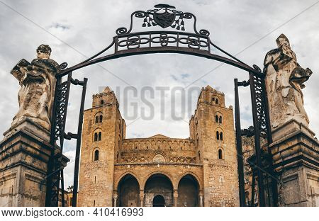Cefalu, Italy - March 6, 2020: Entrance gate to the Cathedral Basilica of Cefalu or Duomo di Cefalu in the old town of coastal city Cefalu, Sicily, Italy