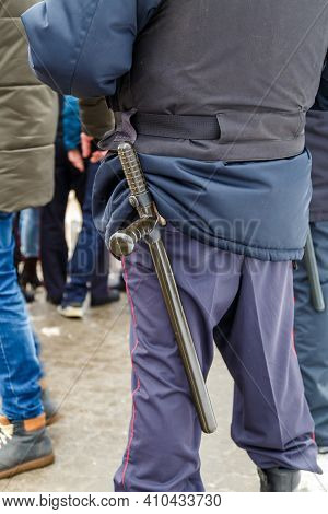 Russian Police Officer With Black Rubber Tonfa Baton Sticking Out From Uniform