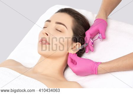 The Doctor Cosmetologist Makes The Injections Procedure For Smoothing Wrinkles And Against Flabbines