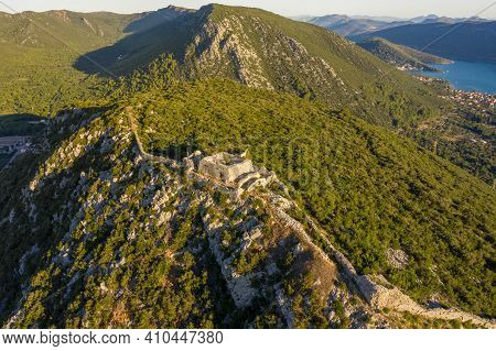 Aerial Drone Shot Of Fortress Of City Of Ston On Top Of Hill In Ragusa Near Dubrovnik In Croatia Sun