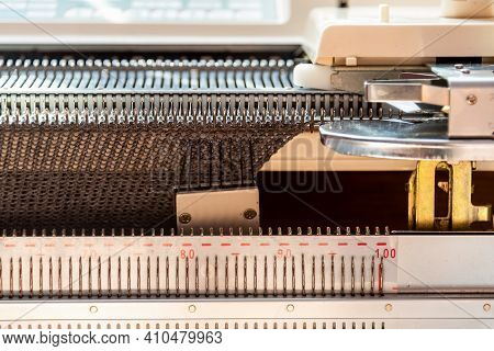 Knitting Machine Close Up View. Hand Knitted Machine As Equipment For Small Business Of Garment Maki