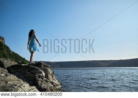 Attractive Woman With Brown Hair Standing Near Dniester River And Enjoying Sunny Weather. Happy Lady