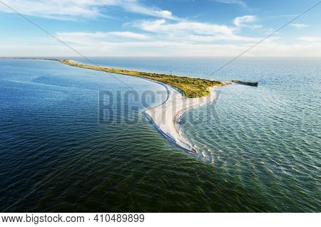 Old shipwreck reinforced concrete barge abandoned stand on beach on the coast of Black sea in Kinburn peninsula, Ukraine