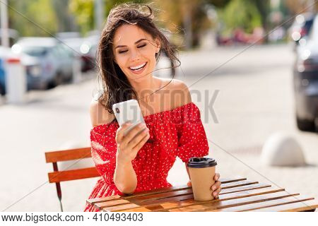 Photo Of Funny Adorable Young Woman Dressed Red Off-shoulders Dress Drinking Coffee Chatting Modern 