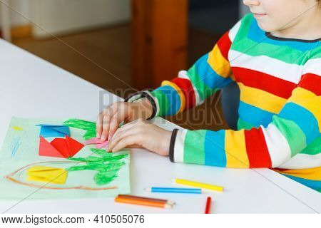 Little Kid Boy Making Paper Origami Tulip Flowers For A Postcard For Mothers Day Or Birthday. Cute C
