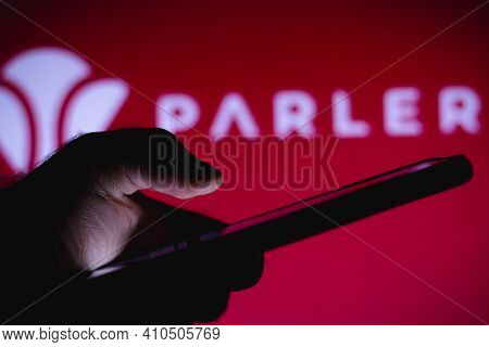 March 1, 2021, Brazil. In This Photo Illustration The Parler Logo Seen In The Background Of A Silhou