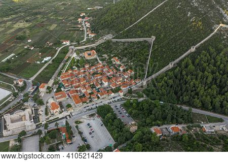 Aerial Drone Shot Of Ston City Wall Over Hill In Ragusa Region Near Dubrovnik In Croatia Summer Sunr