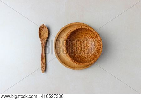 Wooden Utensils On The Kitchen Table. Round Wooden Plates, A Wooden Spoon. The Concept Of Serving, C