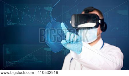 Medical technology concept. Doctor wearing virtual reality glasses checking human heart with simulator interface. Innovative technology in science and medicine.