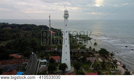 Aerial View Of Lighthouse Sea Rock Sunset Landscape. Sunset Lighthouse Scene. At Anyer Beach With No