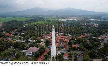 Aerial View Of Lighthouse Sea Rock Sunset Landscape. Sunset Lighthouse Scene. At Anyer Beach With No