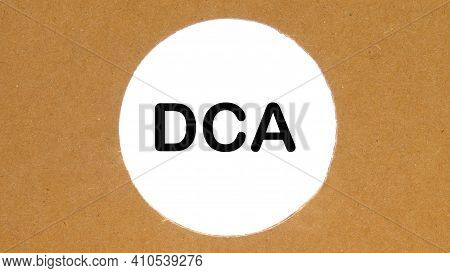 Dca Text In A Cardboard Hole On A White Background