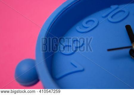 Number 8 Shown On A Blue Clock On A Pink Background