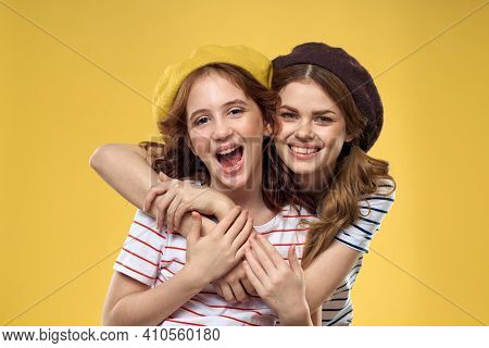 Mom And Daughter Embrace Joy Fun Childhood Lifestyle Yellow Background