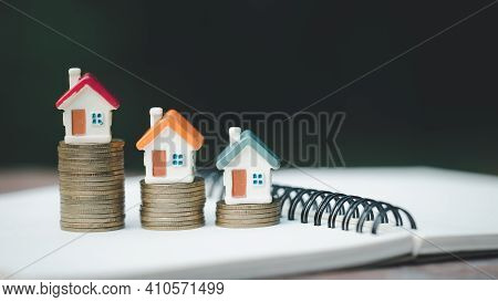 Mini House On Stack Of Coins,money And House,  Mortgage, Savings Money For Buy House And Loan To Bus