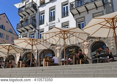 Konstanz, Germany - July 2020: Cafe With Tables With Umbrellas And Reaxing People At Town Square In 