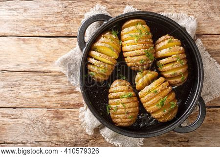 Swedish Baked Hasselback Potatoes Close-up On A Frying Pan On The Table. Horizontal Top View From Ab