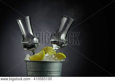 Tequila With Lime Clices In A Metal Bucket With Ice. Copy Space.