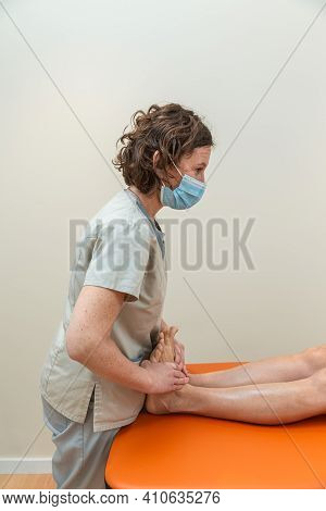 Physiotherapist And Patient In Global Postural Re-education Session, With Pandemic Protection Mask.